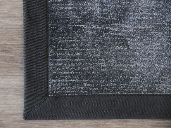Handwoven charcoal border rug with two-tone loop-tip texture
